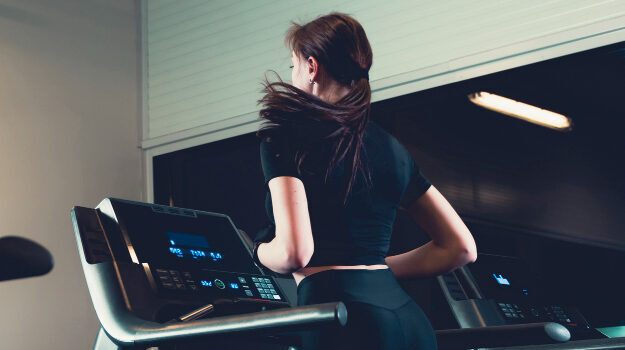 rear-view-woman-running-treadmill-2